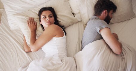 Adult couple experiencing emotional distance in bed